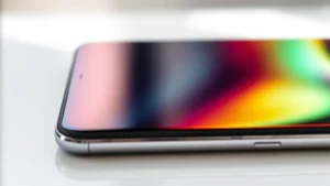 Close-up of premium smartphone display showing vibrant colors and high refresh rate in action with natural lighting reflecting off the screen