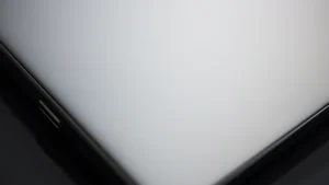 Close-up of premium metallic and matte gadget surface showing texture and build quality, soft professional lighting, shallow depth of field, tech photography style